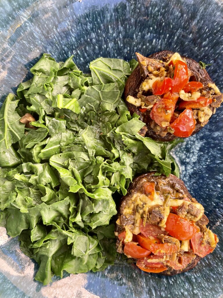 Steamed Kale and Stuffed Mushrooms with cherry tomatoes and arugula vegan pesto, smoked manchego cheese or no cheese.