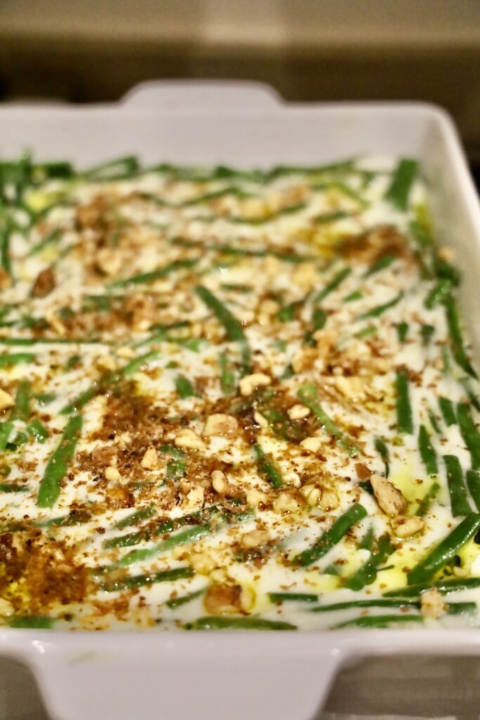 Close up of green bean casserole in a white mason pan