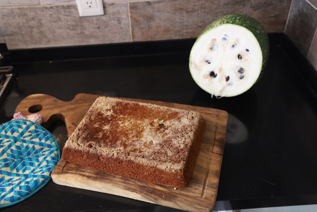 Quinoa loaf is shown after removing from it's baking dish and is featured on a wood cutting board.