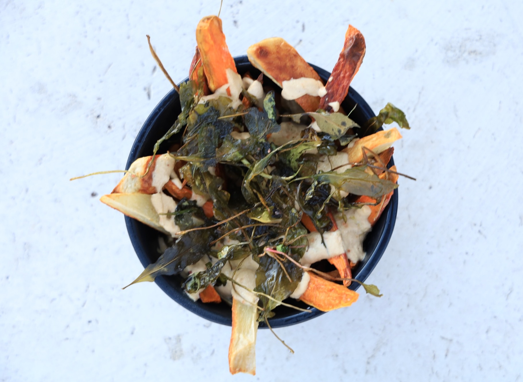 sweet potato fries covered with nacho sauce and deep fried greens