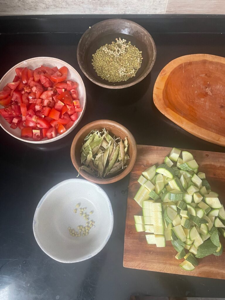 all the vegetable ingredients in separate bowls, the peas have only started to be shucked