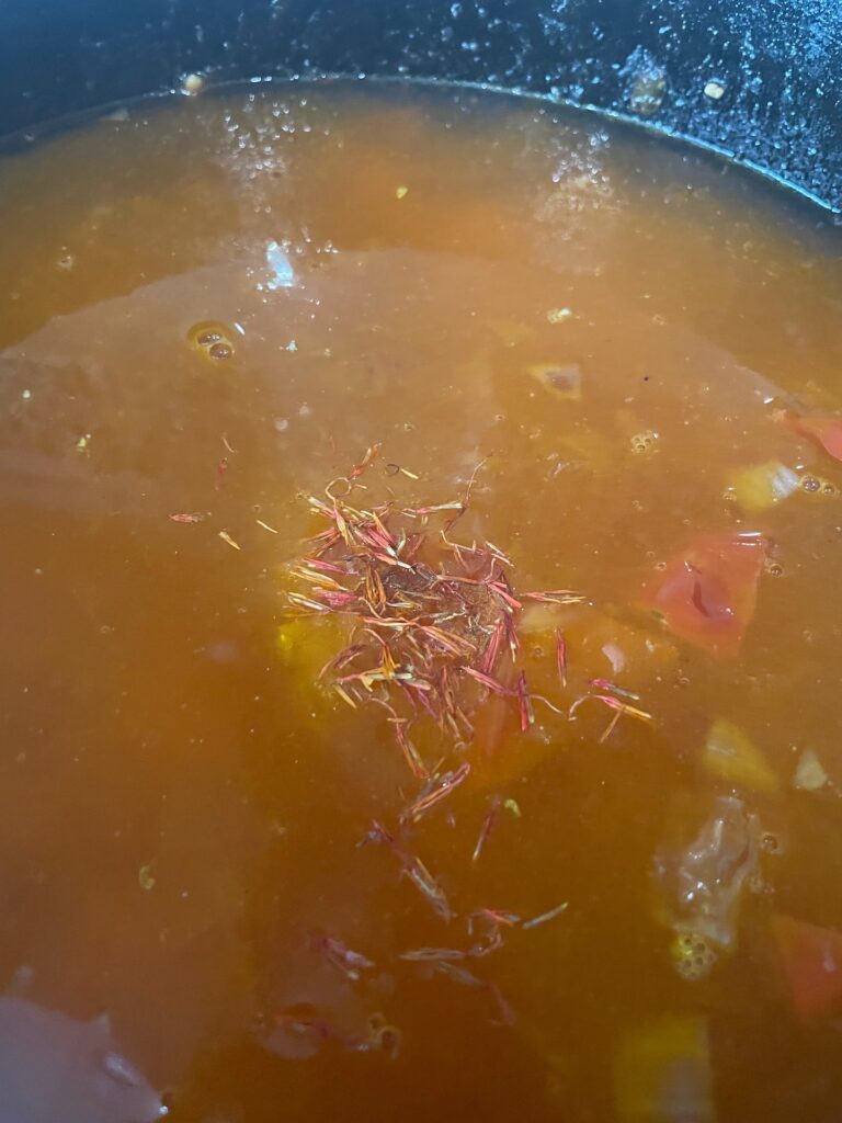 adding saffron to the broth